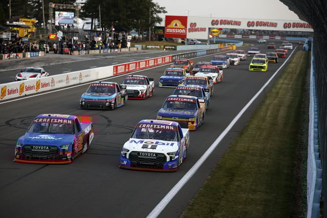 Christopher Bell, driver of the #52 Halmar International Toyota, and Corey Heim, driver of the #11 Mobil 1 Toyota, lead the field during the NASCAR Craftsman Truck Series Mission 176 at The Glen at Watkins Glen International on August 08, 2025 in Watkins Glen, New York.