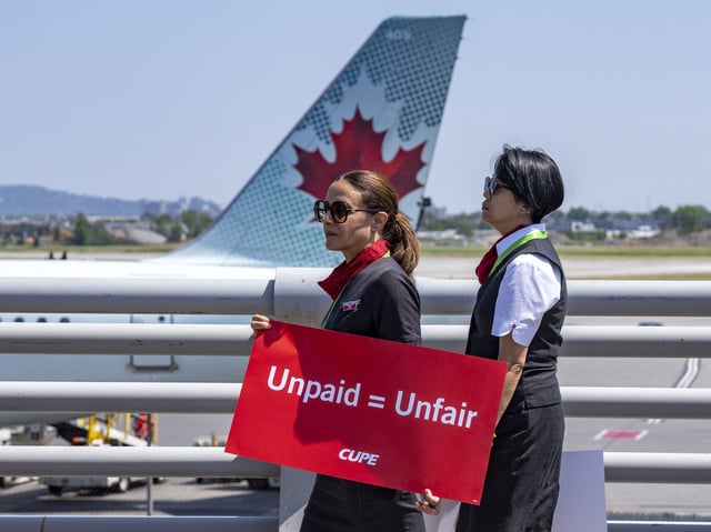 Air Canada flight attendants hold a silent protest at Montreal-Pierre Elliott Trudeau International Airport in Montreal, on Monday, Aug. 11, 2025. THE CANADIAN PRESS/Christinne Muschi