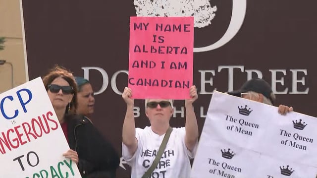 Protestors who are opposed the idea of Alberta's separation from Canada gather outside a town hall hosted by the Alberta Next panel in Edmonton on Thursday evening.