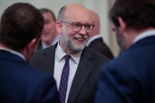 Office of Managment and Budget Director Russell Vought talks with fellow guests at a reception hosted by President Donald Trump for Republican members of the House of Representatives in the East Room of the White House on July 22, 2025, in Washington, DC.