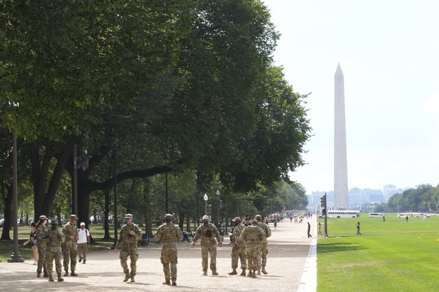 Soldiers from the District of Columbia National Guard patrol along the National Mall Thursday, Aug. 14, 2025, in Washington. The Washington Monument is seen in the distance. (AP Photo/Jacquelyn Martin)