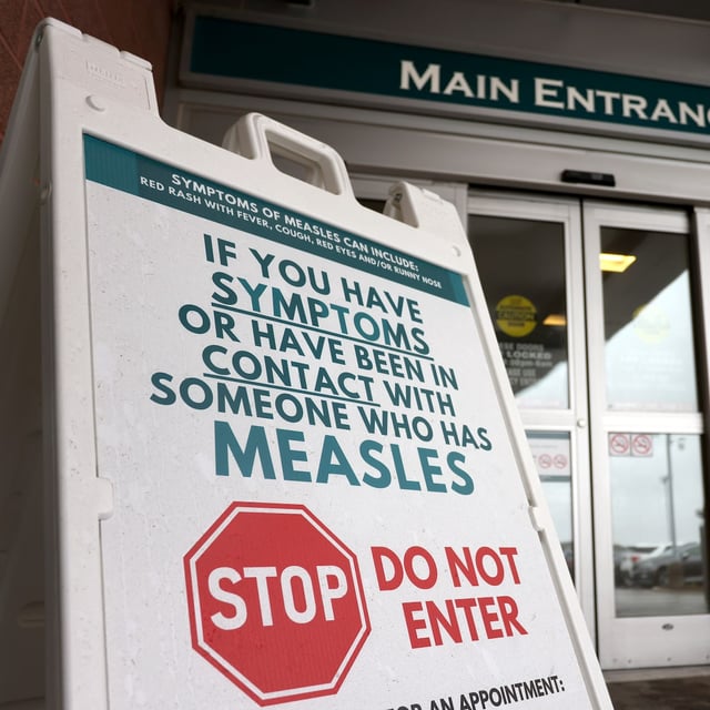 Warning signage for suspected cases of measles is seen outside the main entrance of Woodstock General Hospital in Woodstock, Ont., Thursday, May 22, 2025. THE CANADIAN PRESS/Nicole Osborne