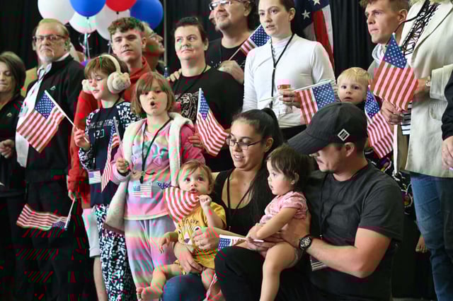 The first group of Afrikaners from South Africa to arrive for resettlement listen to remarks from U.S. Deputy Secretary of State Christopher Landau and U.S. Deputy Secretary of Homeland Security Troy Edgar (both out of frame), after they arrived at Washington Dulles International Airport in Dulles, Virginia, on May 12, 2025.