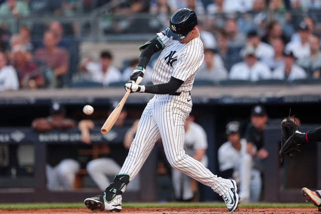 NEW YORK, NEW YORK - AUGUST 11: Cody Bellinger #35 of the New York Yankees hits a solo home run during the first inning of the game against the Minnesota Twins at Yankee Stadium on August 11, 2025 in New York City.