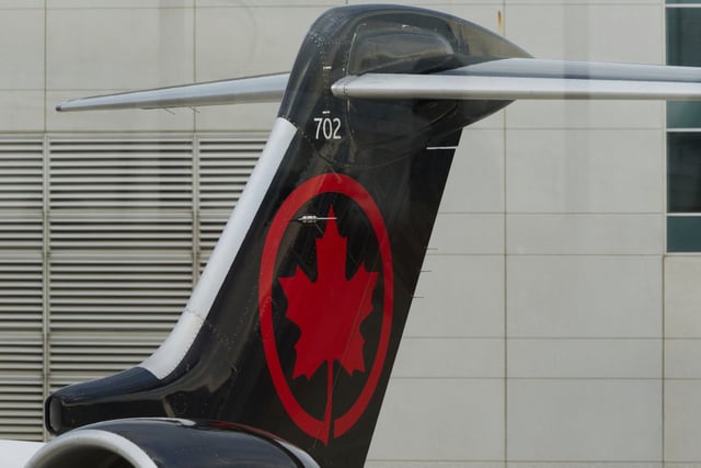 An Air Canada Express Bombardier CRJ900 operated by Jazz Aviation LP sits on the tarmac at Cincinnati/Northern Kentucky International Airport outside of Hebron, Ky., Friday, Aug. 15, 2025. (AP Photo/Jon Gambrell)