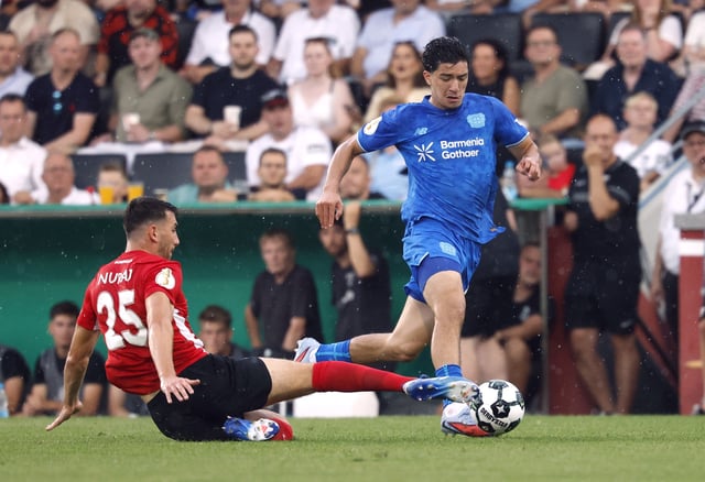 Soccer Football - DFB Cup - First Round - SG Sonnenhof Grossaspach v Bayer Leverkusen - WIRmachenDRUCK Arena, Aspach, Germany - August 15, 2025 Bayer Leverkusen's Ibrahim Maza in action with SG Sonnenhof Grossaspach's Arbnor Nuraj REUTERS/Heiko Becker