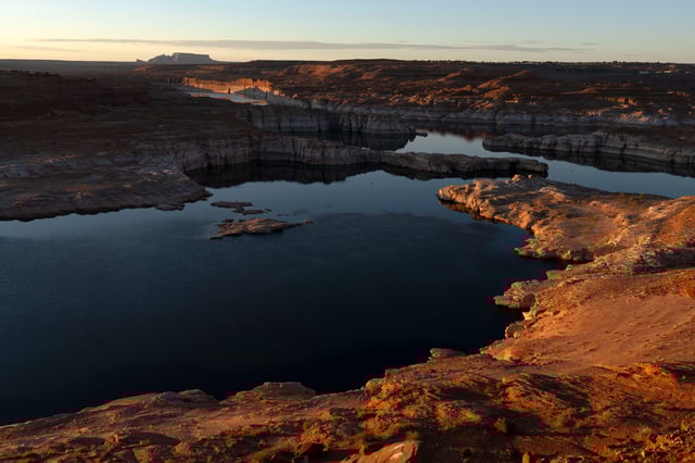 The sun rises over Lake Powell in Glen Canyon National Recreation Area on July 10, 2025 in Page, Arizona. Lake Powell, a critical Colorado River reservoir, is only at a third of its capacity as drought conditions in the Southwest worsen.