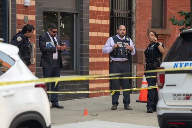 NYPD officers and detectives investigate a fatal stabbing outside 306 W. 128th St. Friday,  Aug. 15, 2025 in Manhattan, New York. (Barry Williams/ New York Daily News)