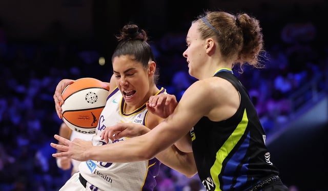 Sparks guard Kelsey Plum, left, drives to the basket as the Dallas Wings’ Maddy Siegrist defends during the second half on Friday night in Arlington, Texas. (Photo by Stacy Revere/Getty Images)