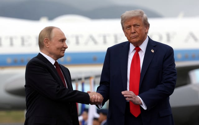 Russian President Vladimir Putin and U.S. President Donald Trump pose on a podium on the tarmac after they arrived to attend a meeting at Joint Base Elmendorf-Richardson in Anchorage, Alaska, U.S., August 15, 2025. Sputnik/Gavriil Grigorov/Pool via REUTERS