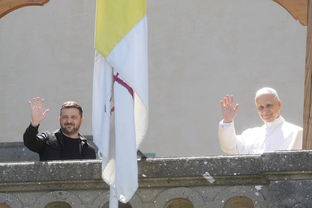 FILE - Ukraine President Volodymyr Zelenskyy, left, and Pope Leo XIV wave to journalists during their meeting in Castel Gandolfo, Italy, Wednesday, July 9, 2025. (AP Photo/Gregorio Borgia, File)