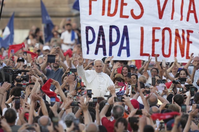 FILE - Pope Leo XIV waves as he arrives to hold a Pentecost vigil in St. Peter's Square at The Vatican, Saturday, June 8, 2025. (AP Photo/Alessandra Tarantino, File)