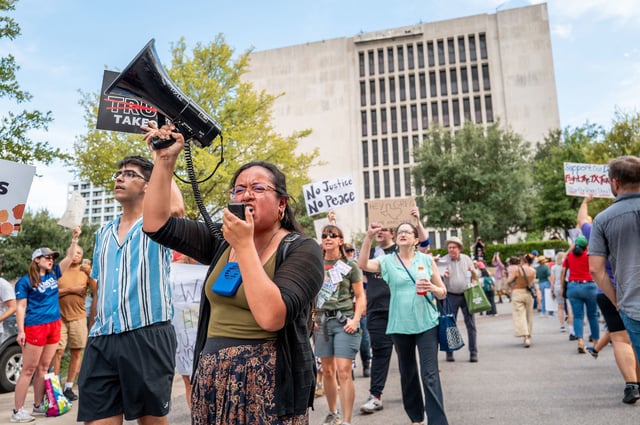 AUSTIN, TEXAS - AUGUST 04: People protest against the recently introduced redistricting legislation during an emergency march and picket rally outside of the Governor's Mansion on August 04, 2025 in Austin, Texas. A crowd gathered to protest the ongoing redistricting proposal, which has garnered nationwide attention, during a special session in the Texas legislature. Texas Democratic lawmakers have fled the state in an attempt to protest and deny the proposed plan. Gov. Greg Abbott has threatened to remove lawmakers who do not return by today. (Photo by Brandon Bell/Getty Images)