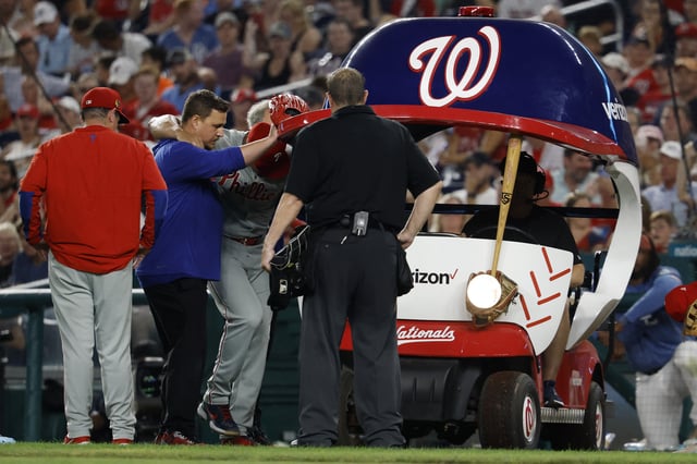 Aug 15, 2025; Washington, District of Columbia, USA; Philadelphia Phillies pitcher Jhoan Duran (59) is helped into the bullpen cart after being hit on the leg by a line drive by Washington Nationals third baseman Paul DeJong (not pictured) during the ninth inning at Nationals Park. Mandatory Credit: Geoff Burke-Imagn Images