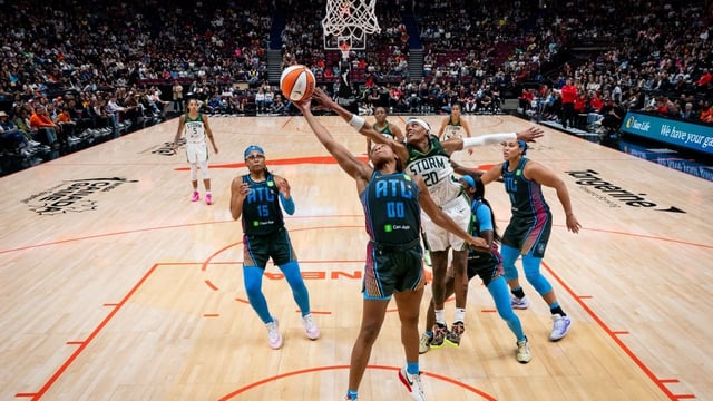 Atlanta Dream's Naz Hillmon (00) and Seattle Storm's Brittney Sykes (20) fight for a rebound during the second half of a WNBA basketball game in Vancouver, B.C., on Friday, August 15, 2025.