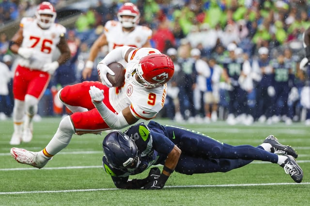 Aug 15, 2025; Seattle, Washington, USA; Seattle Seahawks quarterback Jalen Milroe (6) tackles Kansas City Chiefs wide receiver JuJu Smith-Schuster (9) short of a first down during the first quarter at Lumen Field. Mandatory Credit: Joe Nicholson-Imagn Images