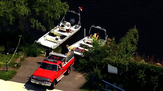 Investigators search the Mississippi River after receiving word of a car found in the river in Sartell, Minnesota, on August 14.