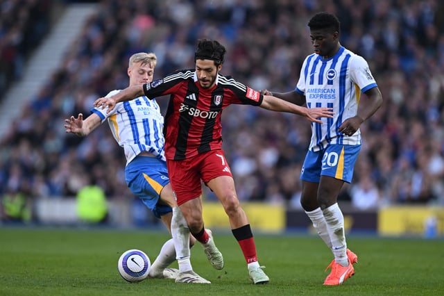Raul Jimenez of Fulham is challenged by Jan Paul van Hecke and Carlos Baleba of Brighton &amp; Hove Albion during the Premier League match between Brighton &amp; Hove Albion FC and Fulham FC at Amex Stadium on March 08, 2025 in Brighton, England.