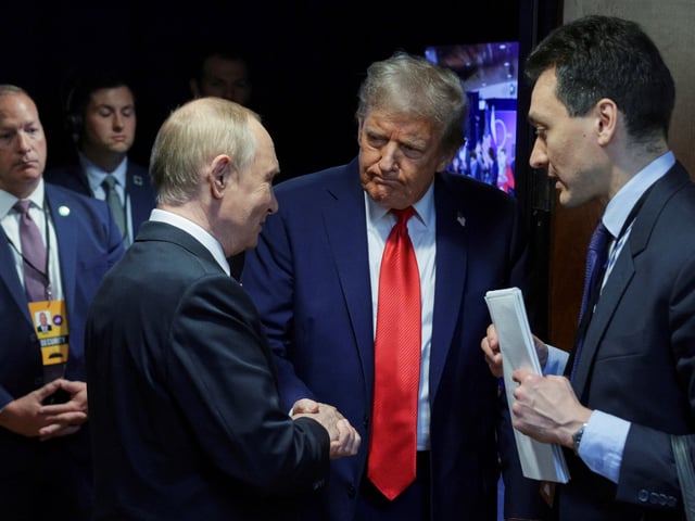 U.S. President Donald Trump, second right, shakes hands with Russian President Vladimir Putin after their joint news conference on Friday, Aug. 15, 2025, at Joint Base Elmendorf-Richardson, Alaska. ((Gavriil Grigorov, Sputnik, Kremlin Pool Photo via AP)