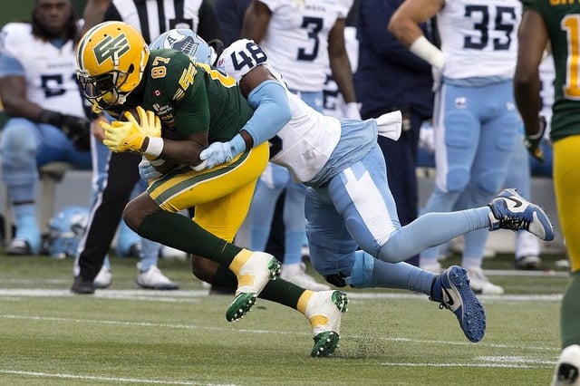 The Edmonton Elks’ Binjimen Victor (87) is tackled by the Toronto Argonauts’ Wynton McManis (48) during CFL action at Commonwealth Stadium, in Edmonton Friday Aug. 15, 2025.