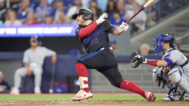 Aug 15, 2025; Toronto, Ontario, CAN; Toronto Blue Jays catcher Alejandro Kirk (30) hits a two run single against the Texas Rangers during the eighth inning at Rogers Centre. Mandatory Credit: John E. Sokolowski-Imagn Images