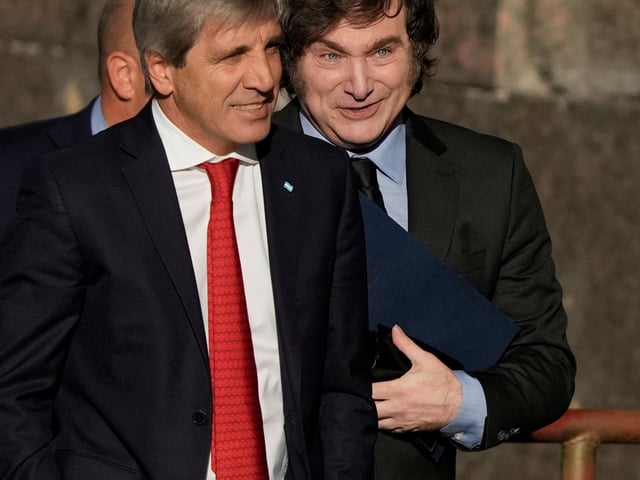 Argentine President Javier Milei, right, and his Economy Minister Luis Caputo enter the Economy Ministry after meeting with U.S. Treasury Secretary Scott Bessent in Buenos Aires, Argentina, Monday, April 14, 2025. (AP Photo/Natacha Pisarenko)