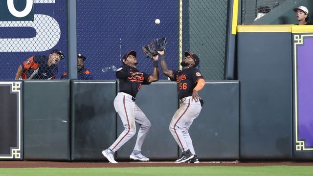 Aug 15, 2025; Houston, Texas, USA; Baltimore Orioles center fielder Daniel Johnson (56) and center fielder Greg Allen (25) attempt to catch a fly ball during the eighth inning against the Houston Astros at Daikin Park. Mandatory Credit: Troy Taormina-Imagn Images