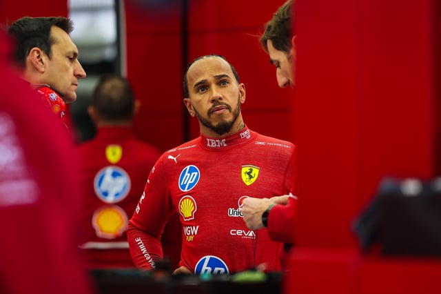 Lewis Hamilton of Great Britain and Ferrari talks to his engineers in the garage during day two of F1 Testing at Bahrain International Circuit on February 27, 2025 in Bahrain, Bahrain.