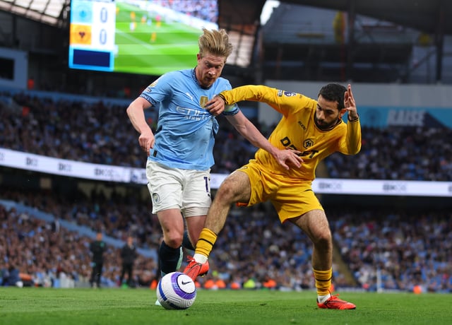 Kevin De Bruyne of Manchester City in action with Rayan Ait-Nouri of Wolverhampton Wanderers during the Premier League match between Manchester City FC and Wolverhampton Wanderers FC at Etihad Stadium on May 2, 2025 in Manchester, England.