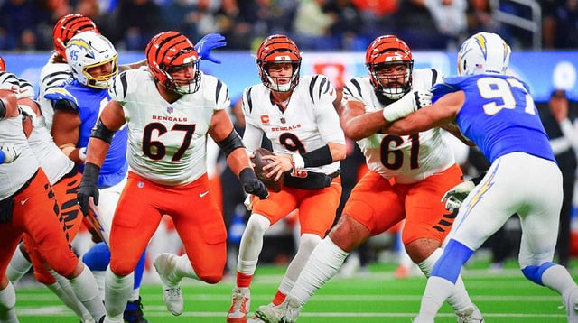 Nov 17, 2024; Inglewood, California, USA; Cincinnati Bengals quarterback Joe Burrow (9) moves out to pass as guard Cody Ford (61) and guard Cordell Volson (67) provide coverage against Los Angeles Chargers linebacker Joey Bosa (97) during the first half at SoFi Stadium. Mandatory Credit: Gary A. Vasquez-Imagn Images