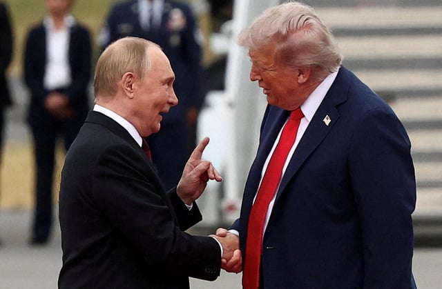 U.S. President Donald Trump shakes hand with Russian President Vladimir Putin, as they meet to negotiate for an end to the war in Ukraine, at Joint Base Elmendorf-Richardson in Anchorage, Alaska, U.S., August 15, 2025. REUTERS/Kevin Lamarque/File Photo