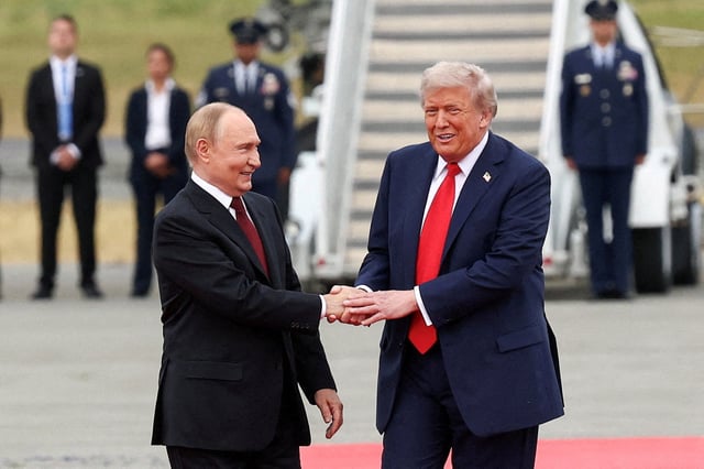 U.S. President Donald Trump shakes hand with Russian President Vladimir Putin, as they meet to negotiate for an end to the war in Ukraine, at Joint Base Elmendorf-Richardson in Anchorage, Alaska, U.S., August 15, 2025. REUTERS/Kevin Lamarque/File Photo