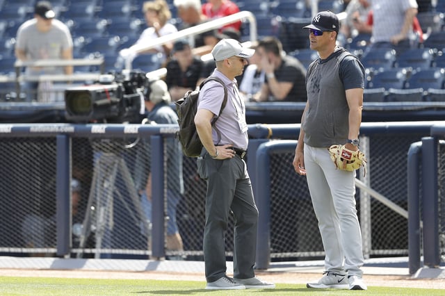 WEST PALM BEACH, FLORIDA - MARCH 12: New York Yankees general manager Brian Cashman talks with manager Aaron Boone prior to a Grapefruit League spring training game against the Washington Nationals at FITTEAM Ballpark of The Palm Beaches on March 12, 2020 in West Palm Beach, Florida. Many professional and college sports are canceling or postponing their games due to the ongoing threat of the Coronavirus (COVID-19) outbreak.