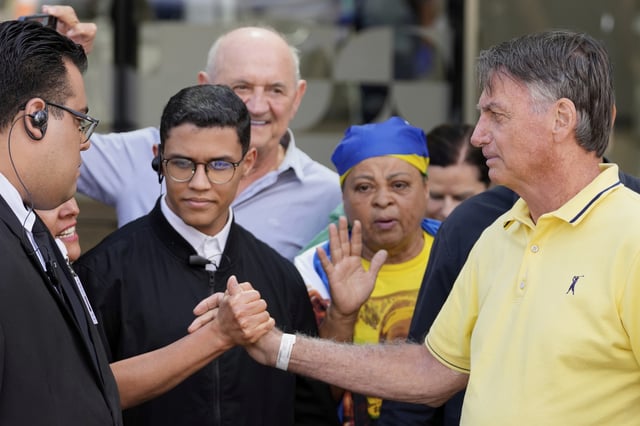 Brazil’s former President Jair Bolsonaro, right, temporarily allowed out of house arrest for medical exams, departs a hospital in Brasília, Brazil, Saturday, Aug. 16, 2025. (AP Photo/Eraldo Peres)