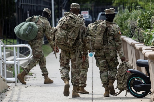 Members of the National Guard depart the DC Armory in Washington, DC, on August 12, 2025 after troops were ordered to report on Tuesday morning, according to media reports