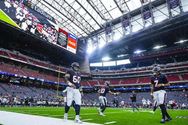 Houston Texans center Jake Andrews (60), quarterback Davis Mills (10) and quarterback C.J. Stroud warm up before a preseason NFL football game against the Carolina Panthers at NRG Stadium in Houston, Saturday, Aug. 16, 2025.
