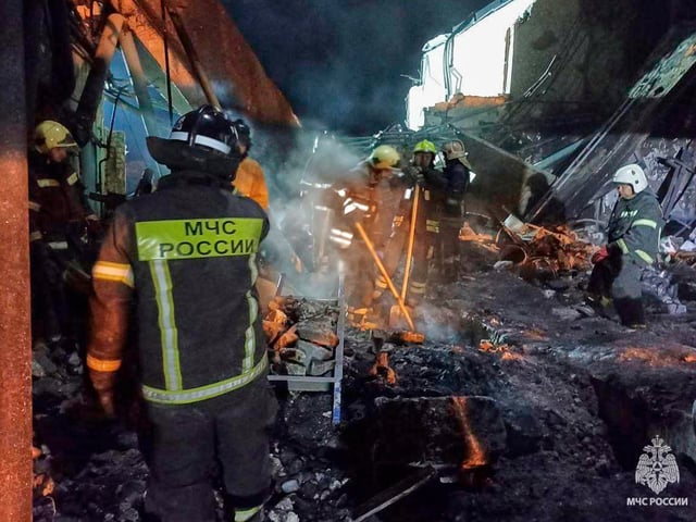 In this photo, released by the Russian Emergency Ministry Press Service on Saturday, Aug. 16, 2025, Emergency Ministry employees work in debris of an industrial plant after a fire at the facility in the Shilovsky District, Ryazan region, around 250 kilometers (155 miles) southeast of Moscow, Russia. (Russian Emergency Ministry Press Service via AP)