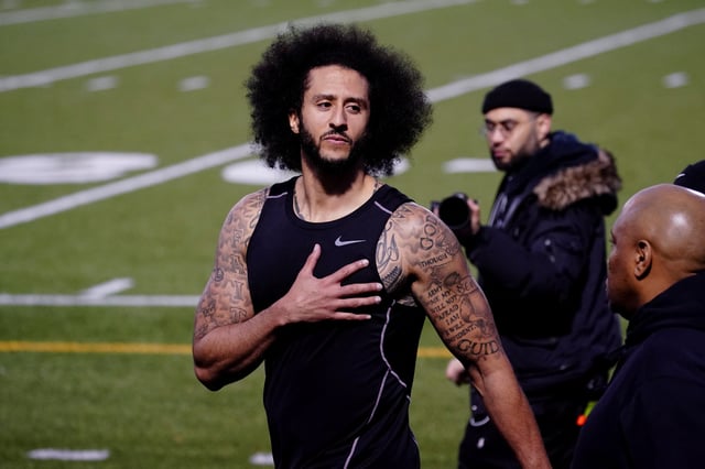 Colin Kaepernick puts his hand over his heart in response to a comment at a special training event created by Kaepernick to provide greater access to scouts, the media, and the public, at Charles. R. Drew High School in Riverdale, Georgia, U.S., November 16, 2019. REUTERS/Elijah Nouvelage/File Photo