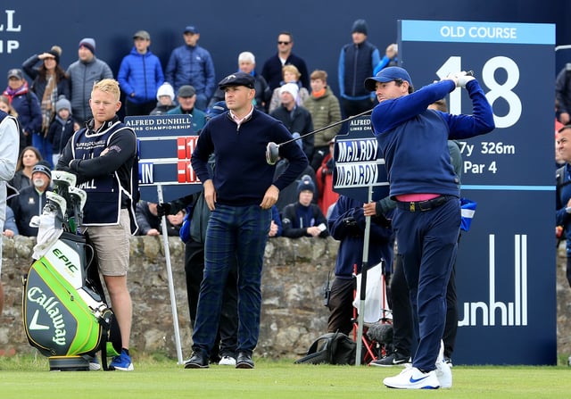 Rory McIlory of Northern Ireland plays his tee shot on the 18th hole watched by his playing partner Harry Hall of England on the 18th hole during the final round of the Alfred Dunhill Links Championship on the Old Course at St Andrews on September 29, 2019 in St Andrews, United Kingdom.