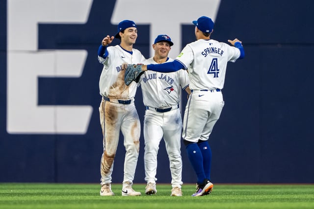 TORONTO, CANADA - AUGUST 22: Joey Loperfido #9, Daulton Varsho #25 and George Springer #4 of the Toronto Blue Jays celebrate after defeating the Los Angeles Angels at Rogers Centre on August 22, 2024 in Toronto, Canada. (Photo by Kevin Sousa/Getty Images)