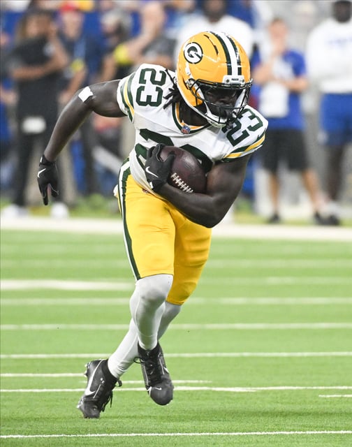 Aug 16, 2025; Indianapolis, Indiana, USA; Green Bay Packers running back Israel Abanikanda (23) runs the ball during the first half against the Indianapolis Colts at Lucas Oil Stadium. Mandatory Credit: Robert Goddin-Imagn Images