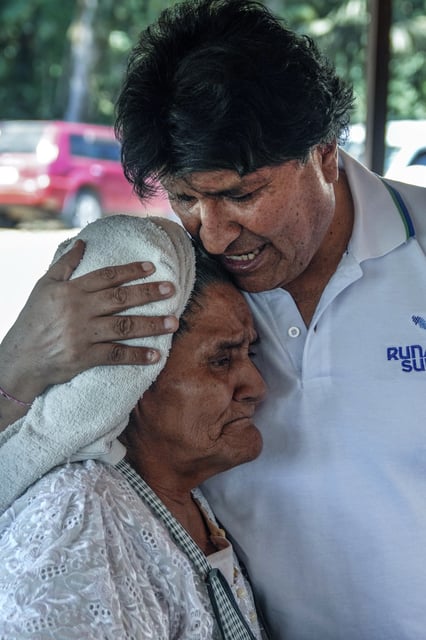 Former President Evo Morales, who is promoting a null vote campaign on the presidential and legislative elections, embraces a woman at a restaurant in Lauca N, Chapare region, Bolivia, Saturday, Aug. 16, 2025. (AP Photo/Jorge Saenz)
