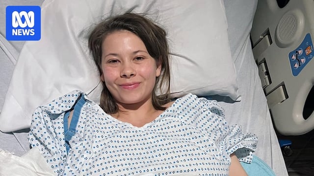 Bindi Irwin smiling in a hospital bed