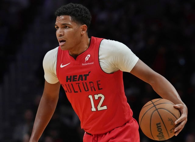 Miami Heat guard Dru Smith (12) dribbles the ball during the first half of an NBA basketball game against the Phoenix Suns, Saturday, Dec. 7, 2024, in Miami. (AP Photo/Marta Lavandier)