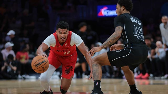 Dec 23, 2024; Miami, Florida, USA; Miami Heat guard Dru Smith (12) slips while dribbling the basketball against Brooklyn Nets guard Keon Johnson (45) during the second quarter at Kaseya Center. Mandatory Credit: Sam Navarro-Imagn Images
