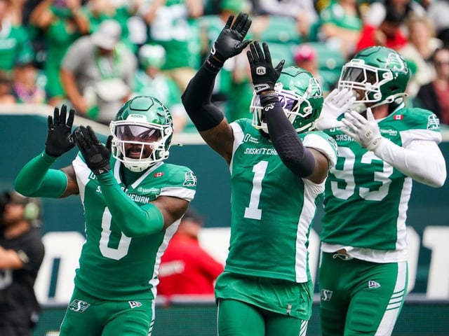 Saskatchewan Roughriders defensive back Rolan Milligan (0) celebrates with defensive back CJ Reavis (1) and defensive lineman Benoit Marion (93) after an interception against the Hamilton Tiger-Cats during the second half of CFL football action in Regina, on Saturday, August 16, 2025.