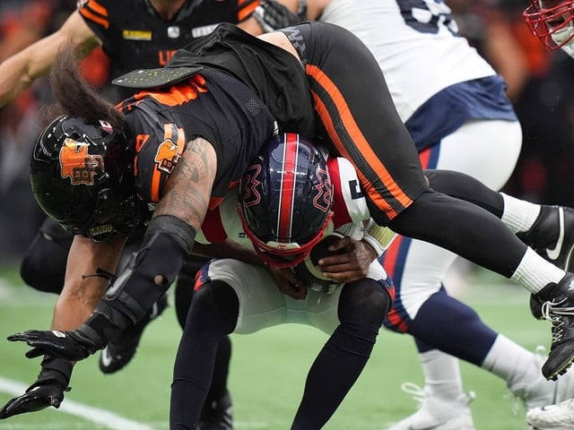  B.C. Lions’ Tomasi Laulile lands on top of Montreal Alouettes quarterback Caleb Evans before he was sacked by B.C.’s Jonah Tavai, not seen, during CFL game, in Vancouver Aug. 16, 2025.