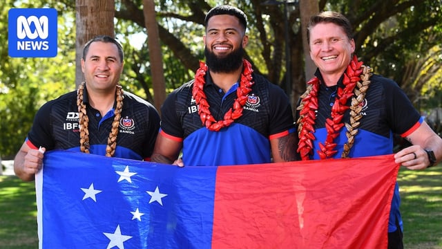Star rugby league player Payne Haas (middle) stands with a Samoa executive and national coach holding a Samoan flag. 