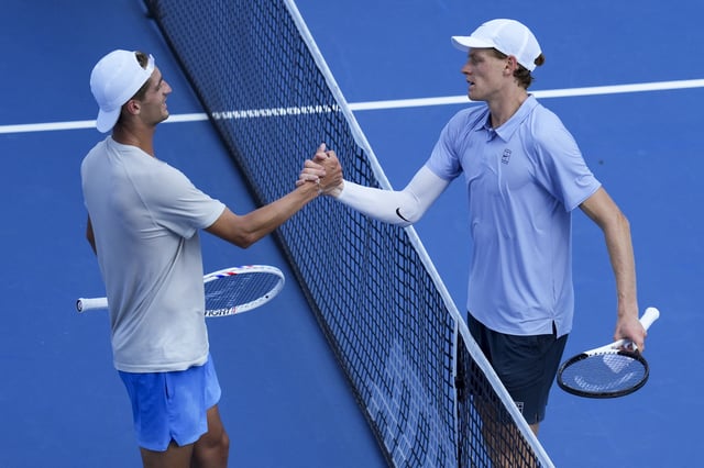 Aug 16, 2025; Cincinnati, OH, USA;  Jannik Sinner (ITA) right, meets Terence Atmane (FRA) at the net after their match during the Cincinnati Open at the Lindner Family Tennis Center. Mandatory Credit: Aaron Doster-Imagn Images