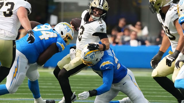 New Orleans Saints quarterback Jake Haener (3) is pressured by Los Angeles Chargers defensive tackle TeRah Edwards (94) and linebacker Garmon Randolph (97) in the second half at SoFi Stadium. Mandatory Credit: Kirby Lee-Imagn Images